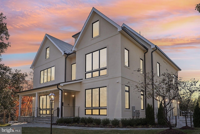 view of front of home featuring covered porch and stucco siding