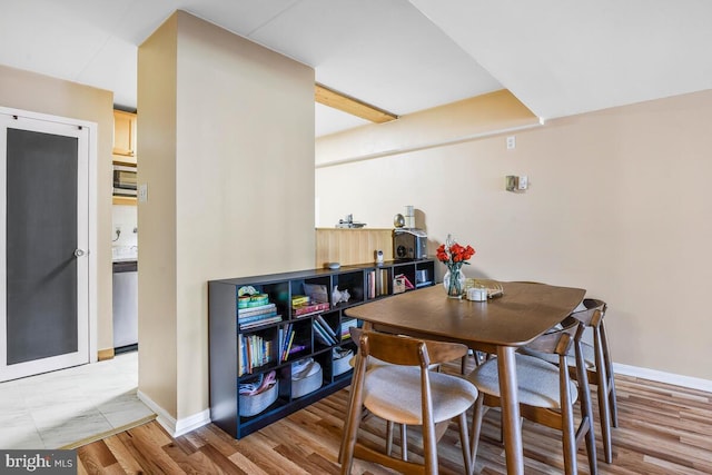 dining area featuring wood finished floors and baseboards