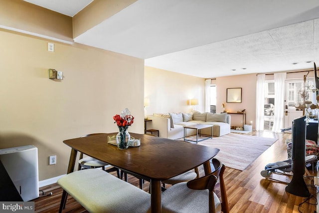 dining area featuring wood finished floors and baseboards