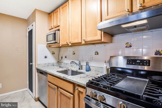 kitchen featuring under cabinet range hood, stainless steel appliances, a sink, baseboards, and marble finish floor