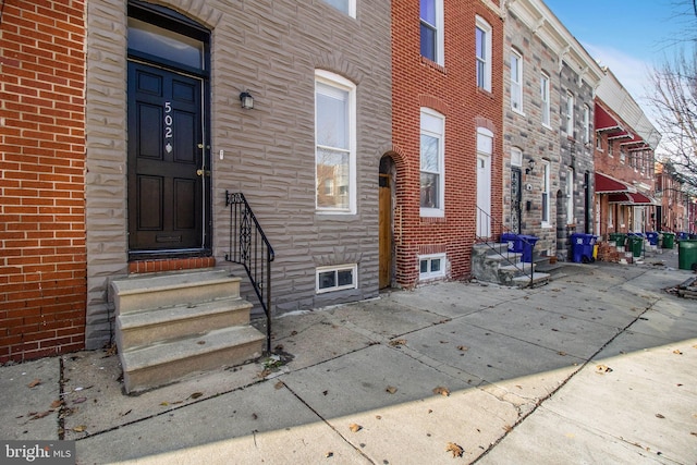 doorway to property with brick siding