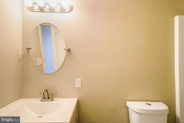 bathroom with toilet and vanity