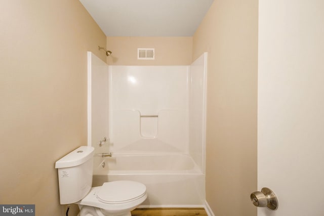 full bathroom with visible vents, toilet, and washtub / shower combination