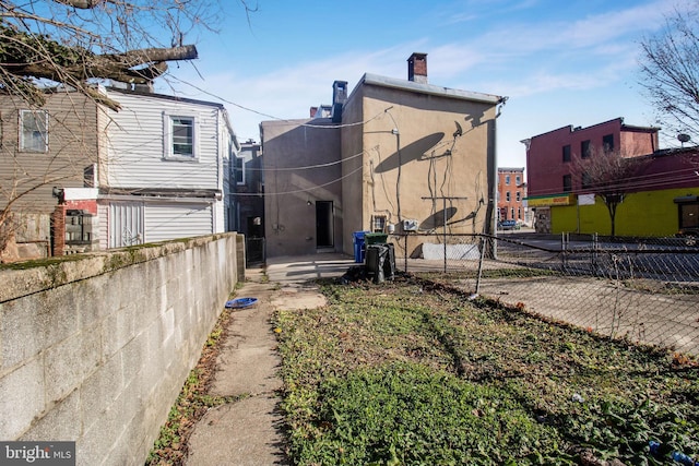 back of property featuring a patio area, fence, and stucco siding