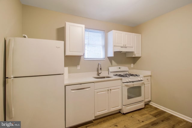 kitchen with white appliances, a sink, under cabinet range hood, white cabinetry, and light wood-type flooring