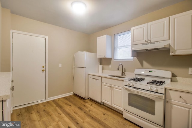 kitchen featuring under cabinet range hood, white appliances, white cabinetry, and a sink