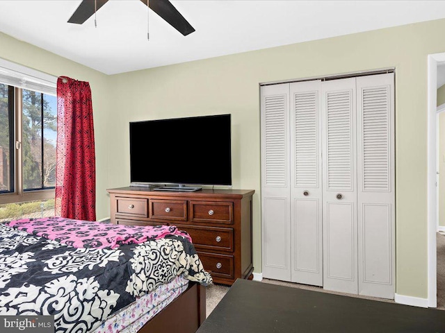 bedroom with a closet, ceiling fan, and baseboards