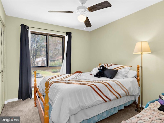 carpeted bedroom featuring a closet, baseboards, and ceiling fan