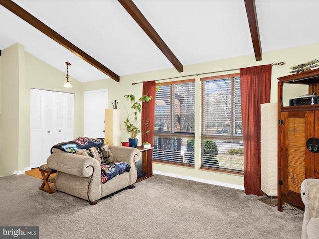 carpeted living area featuring vaulted ceiling with beams