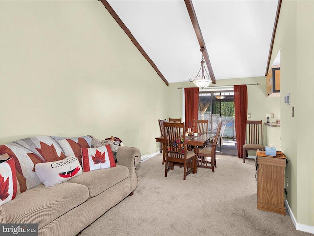 dining space with carpet flooring, high vaulted ceiling, and baseboards