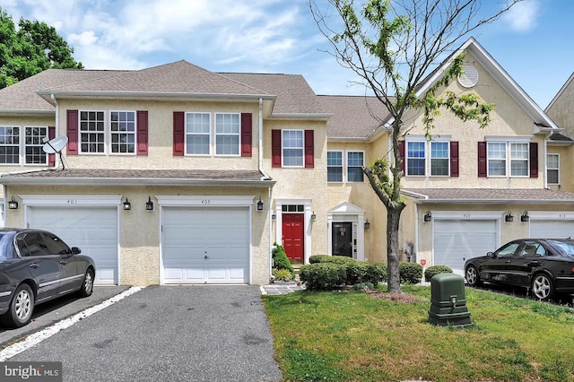 multi unit property with an attached garage, a shingled roof, aphalt driveway, and stucco siding