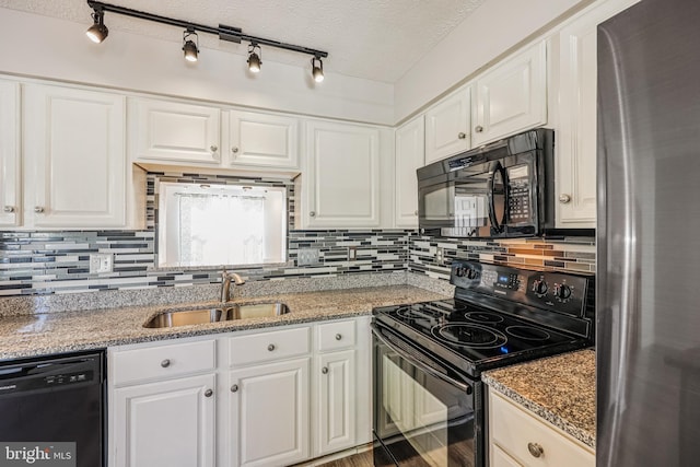 kitchen featuring tasteful backsplash, white cabinetry, black appliances, and a sink