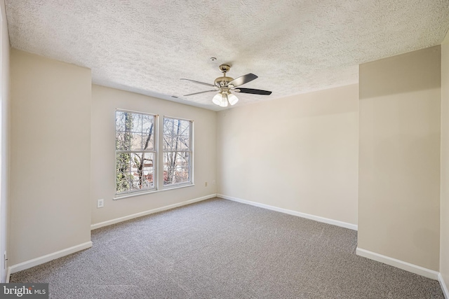 carpeted empty room with baseboards, a textured ceiling, and a ceiling fan