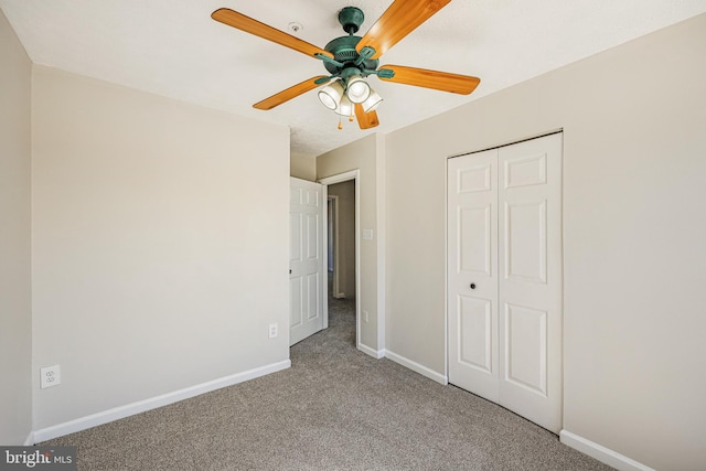 unfurnished bedroom featuring baseboards, carpet floors, a closet, and a ceiling fan