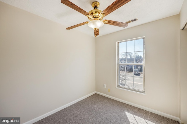 unfurnished room with visible vents, a ceiling fan, baseboards, and carpet floors