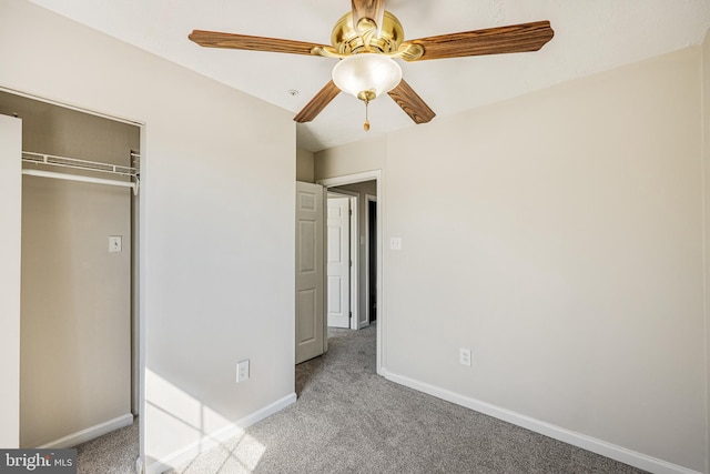 unfurnished bedroom with a closet, baseboards, ceiling fan, and carpet flooring