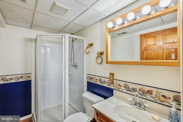 full bath featuring visible vents, a paneled ceiling, a stall shower, and vanity