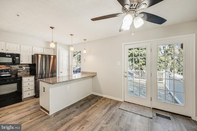 kitchen featuring black appliances, white cabinets, visible vents, and light wood finished floors