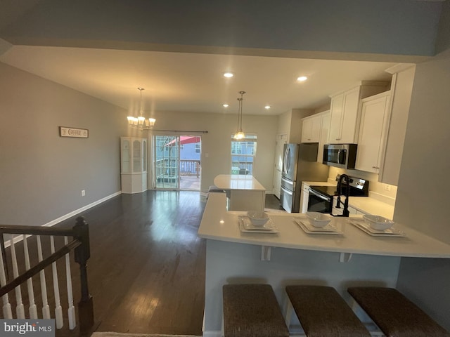 kitchen featuring light countertops, recessed lighting, stainless steel appliances, white cabinetry, and dark wood-style flooring