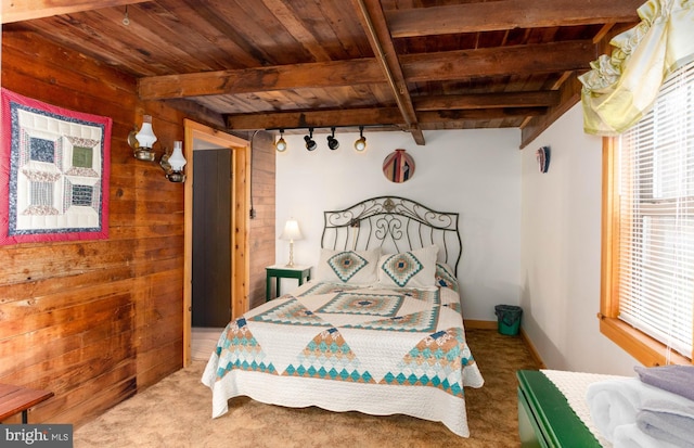 bedroom with wood ceiling, wood walls, and beam ceiling