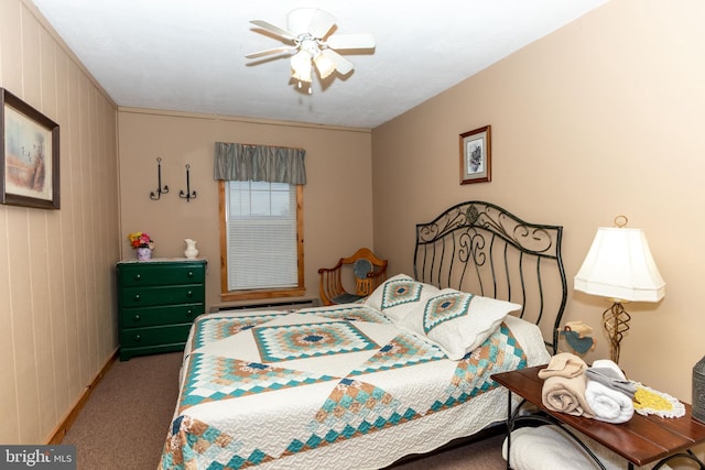 bedroom with carpet, baseboard heating, and a ceiling fan