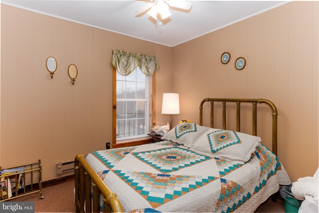 bedroom with a baseboard heating unit, carpet, crown molding, and a ceiling fan