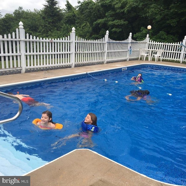 view of swimming pool featuring fence and a fenced in pool