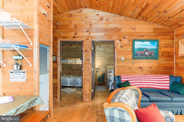 bedroom with wooden ceiling, wood walls, vaulted ceiling, and hardwood / wood-style flooring