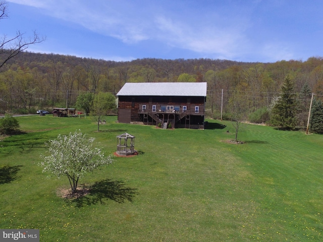 exterior space featuring a forest view