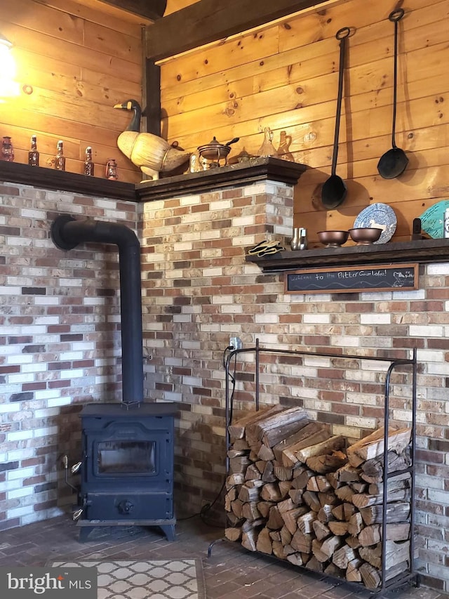 interior space with a wood stove and wooden walls