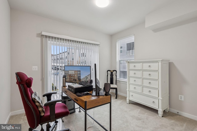 home office with light colored carpet and baseboards