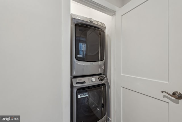 washroom featuring laundry area and stacked washer / dryer