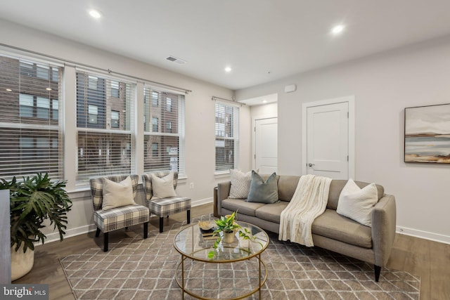 living room featuring wood finished floors, visible vents, and recessed lighting