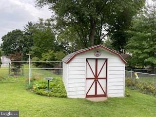 view of shed featuring fence