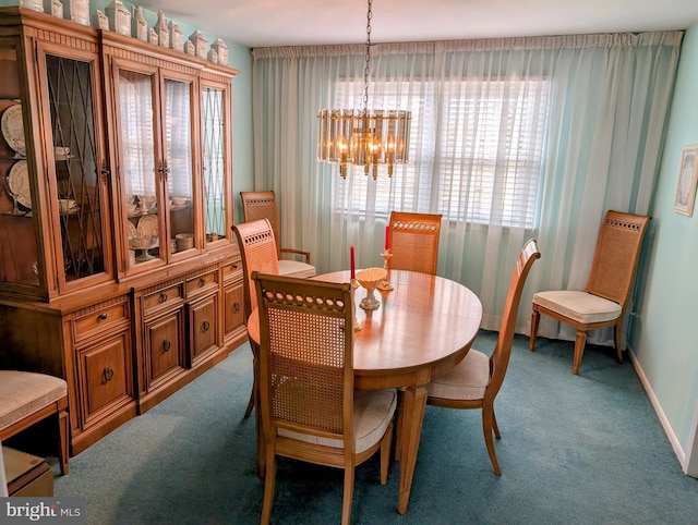 carpeted dining area featuring baseboards and an inviting chandelier