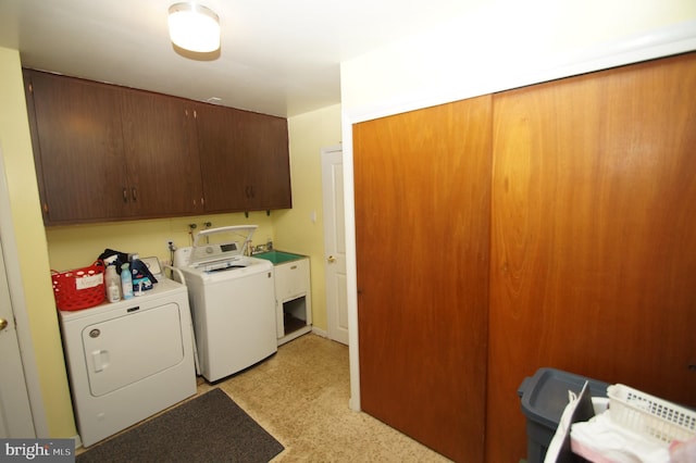 washroom featuring cabinet space and independent washer and dryer