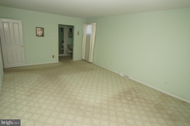 empty room with visible vents and baseboards