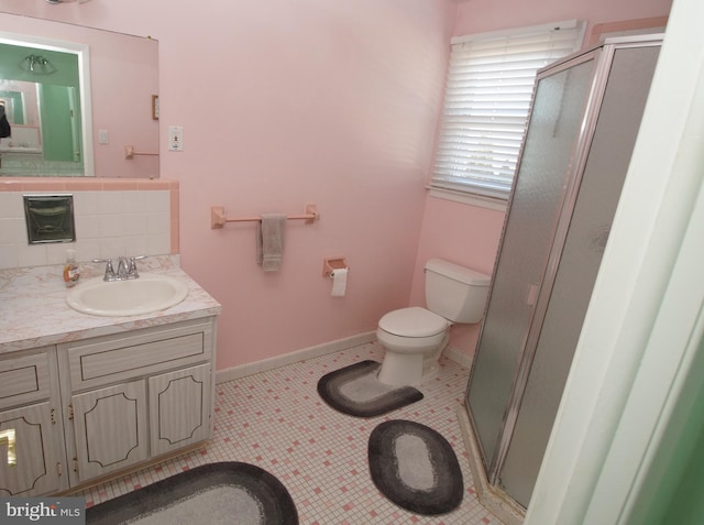 bathroom with tile patterned floors, toilet, tasteful backsplash, a shower stall, and baseboards