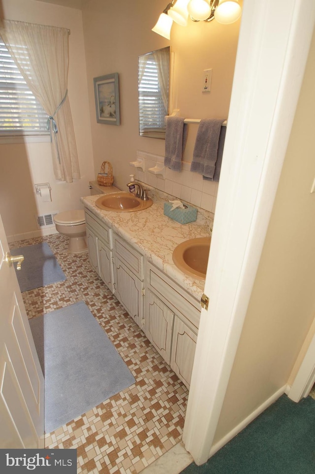 full bathroom featuring a sink, visible vents, and a wealth of natural light