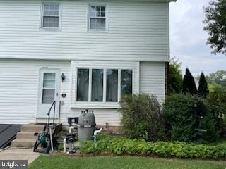 rear view of house featuring entry steps