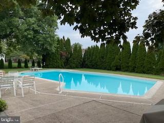 outdoor pool with a patio area