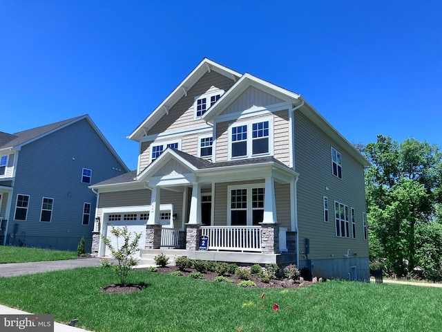1704 Copperleaf Blvd, Hanover, MD 21076 - craftsman-style home featuring covered porch, an attached garage, a front yard, stone siding, and driveway
