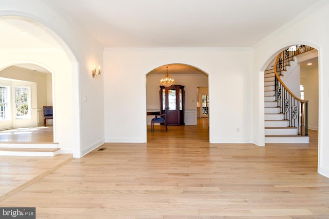 interior space featuring light wood finished floors, stairway, and a healthy amount of sunlight