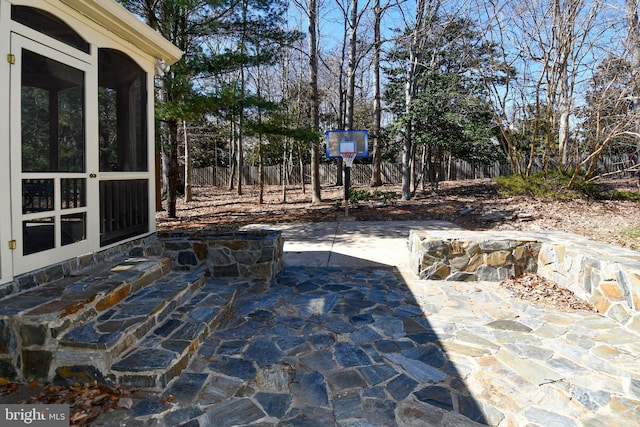 view of patio / terrace featuring a sunroom and a fenced backyard