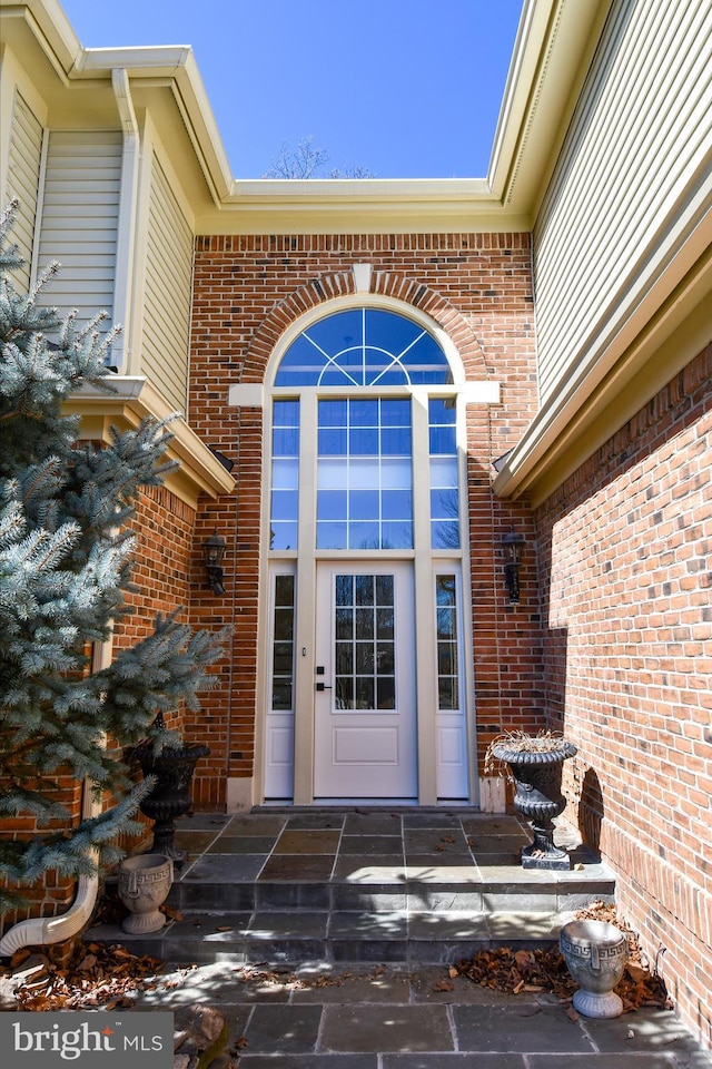 property entrance with brick siding