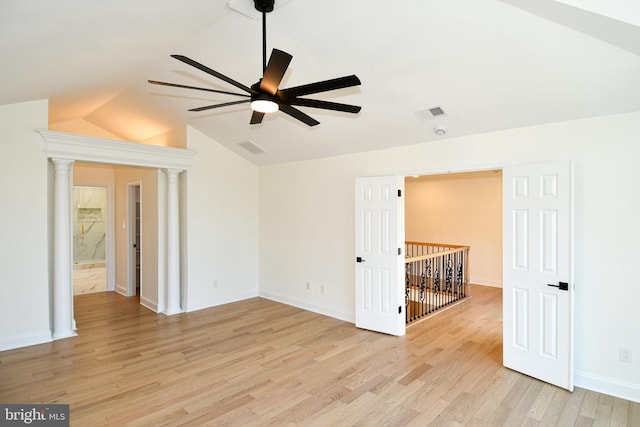 spare room with light wood-style flooring, a ceiling fan, visible vents, vaulted ceiling, and baseboards