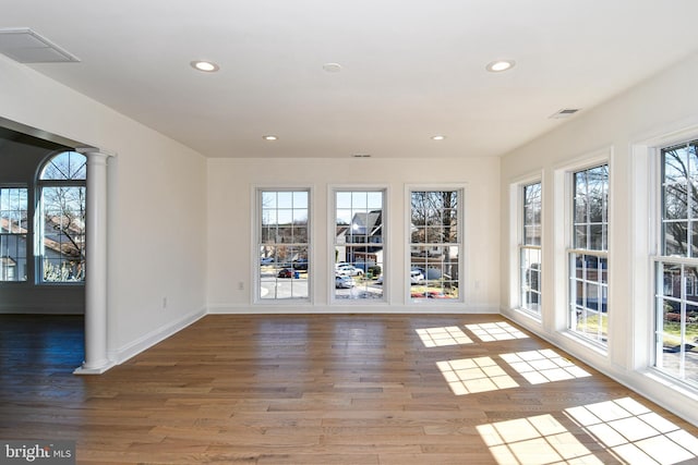 interior space with recessed lighting, visible vents, ornate columns, and wood finished floors