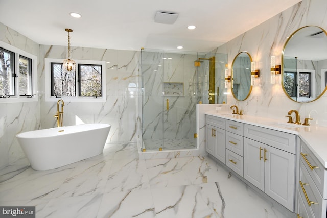 full bath featuring marble finish floor, a sink, and stone wall