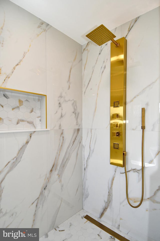 interior space with a marble finish shower