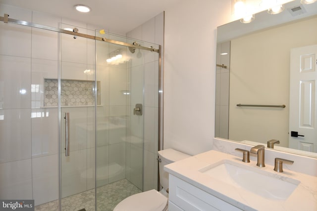 full bath featuring visible vents, a shower stall, toilet, and vanity